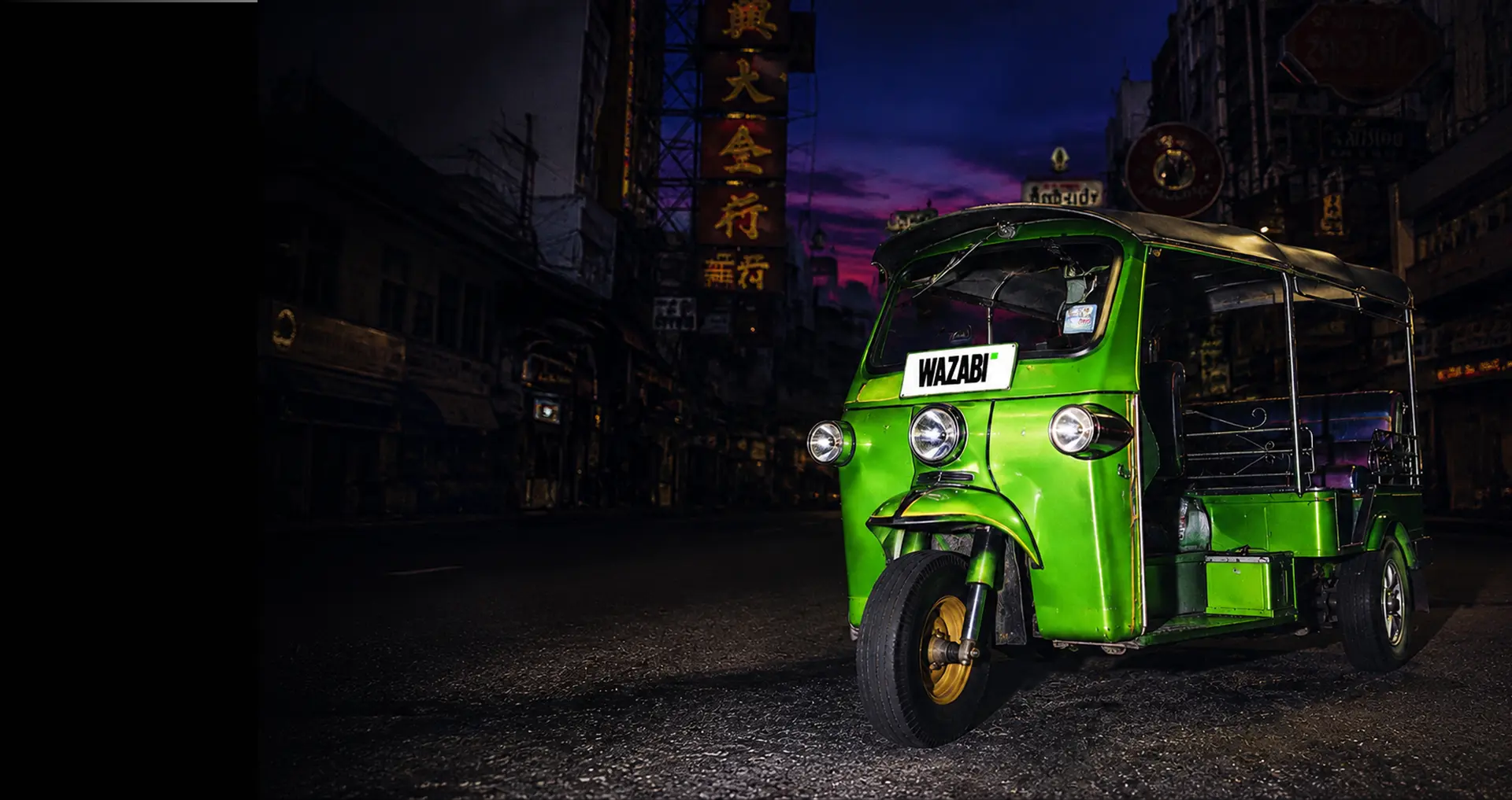 WAZABI tuk-tuk on a city street at night