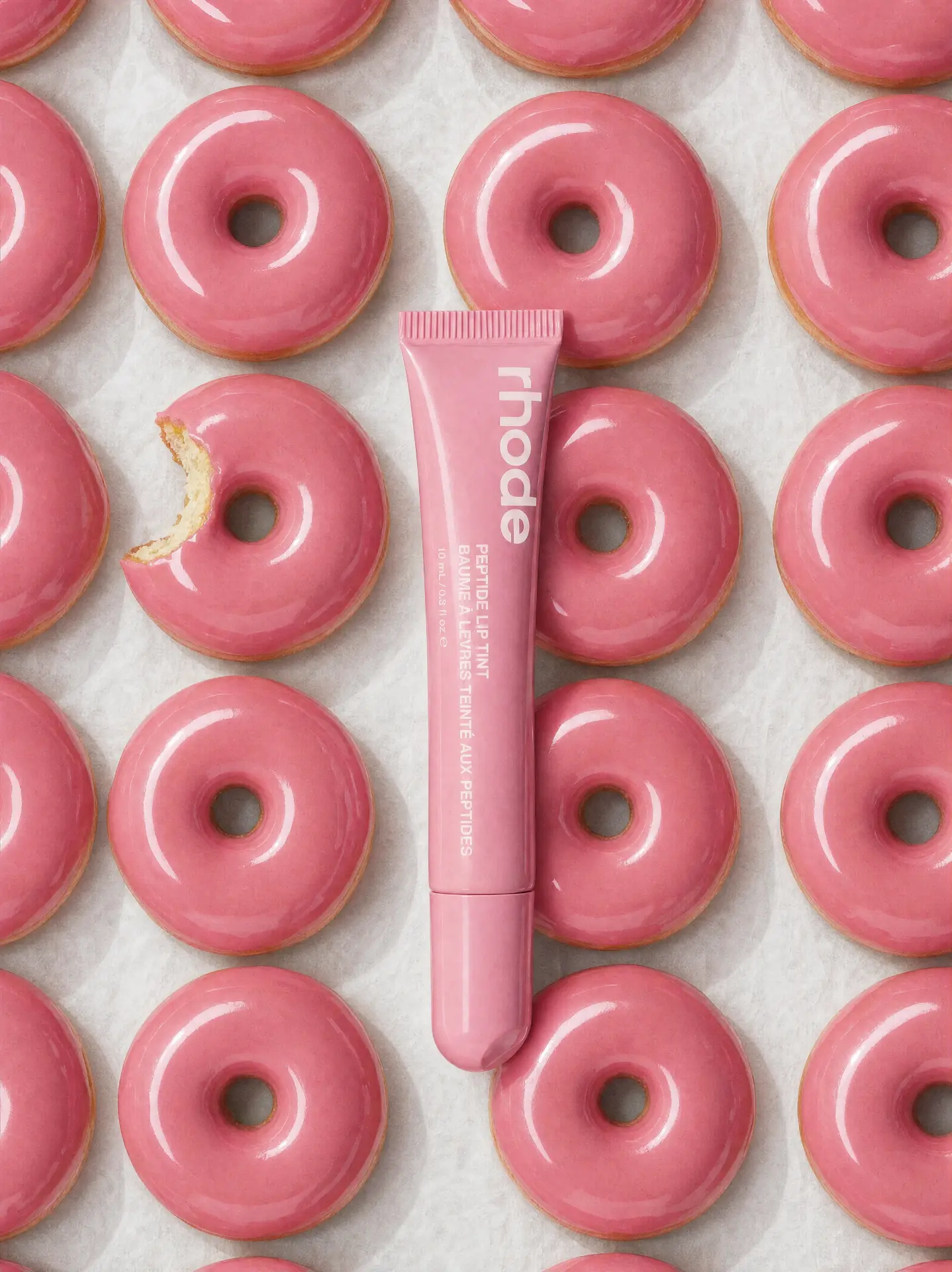 RHODE — LIP TINT ON A GRID OF PINK GLAZED DONUTS